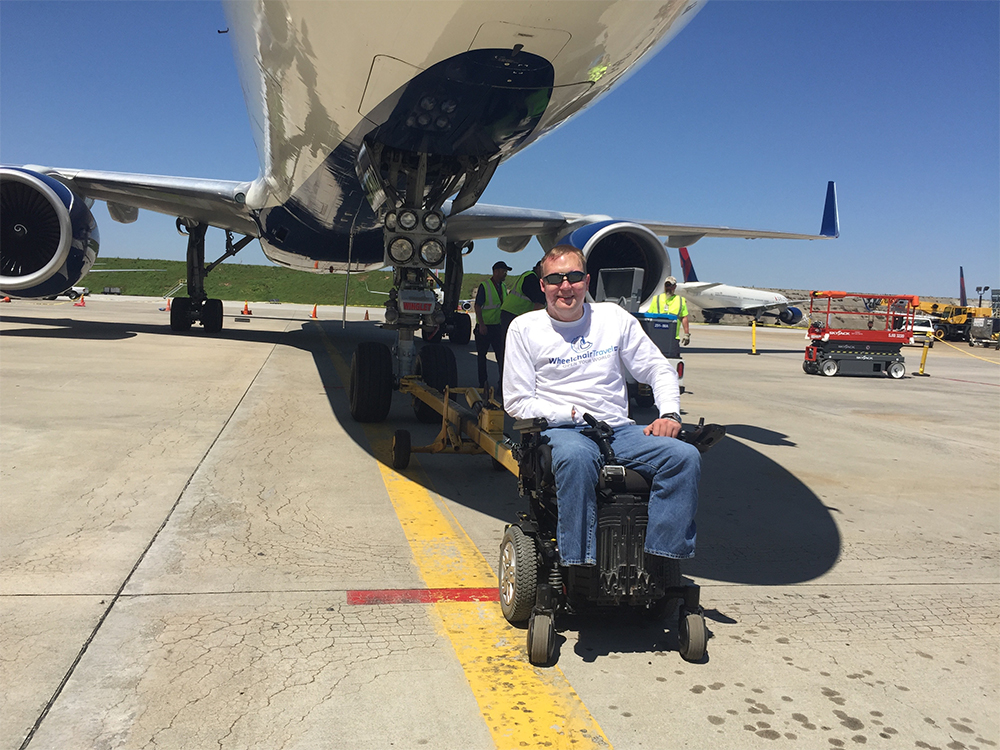 John in front of an airplane