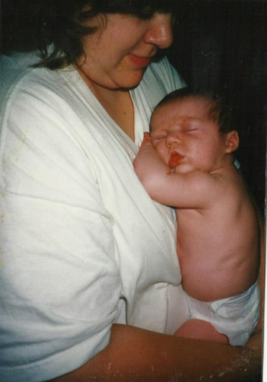 mom holding sleeping baby