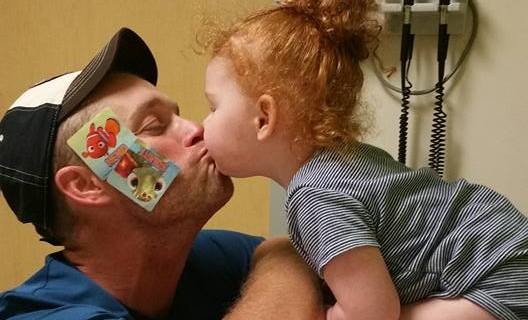 little girl kissing her dad