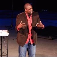 man on stage giving a presentation