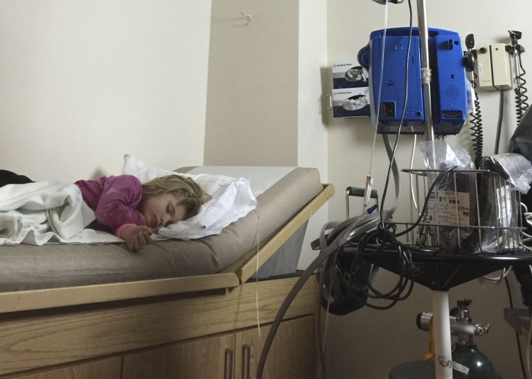 girl lying in hospital bed