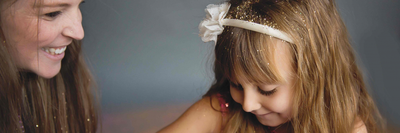 Grief After Child Loss Mom with toddler daughter in pink dress