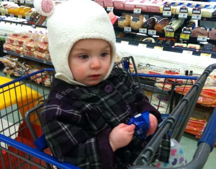 girl wearing bunny hat in shopping cart