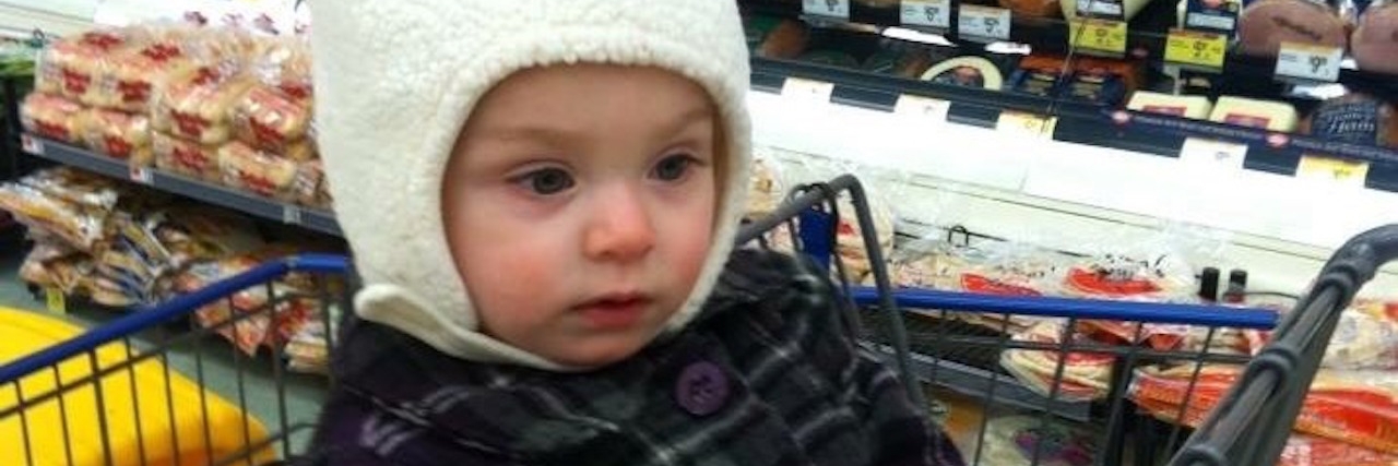 People Judging Me When My Child With Autism Screams in the Store girl wearing bunny hat sitting in a shopping cart