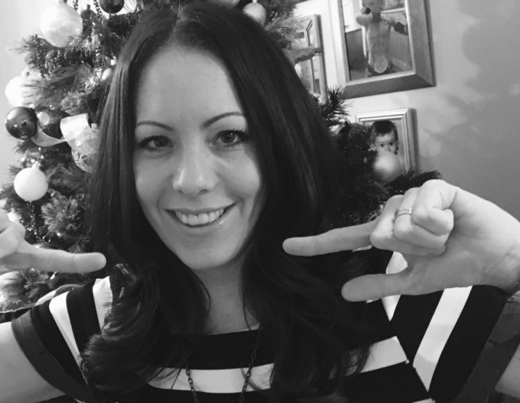 Black and white photo of the author pointing toward herself