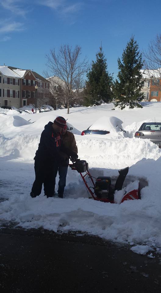 neighbor plowing with snowblower