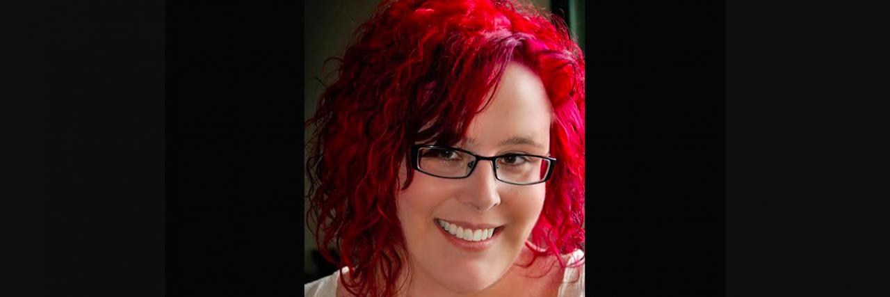 Why I Say I 'Suffer' From Bipolar Disorder Portrait of contributor, a white woman wearing glasses, with red hair, and smiling