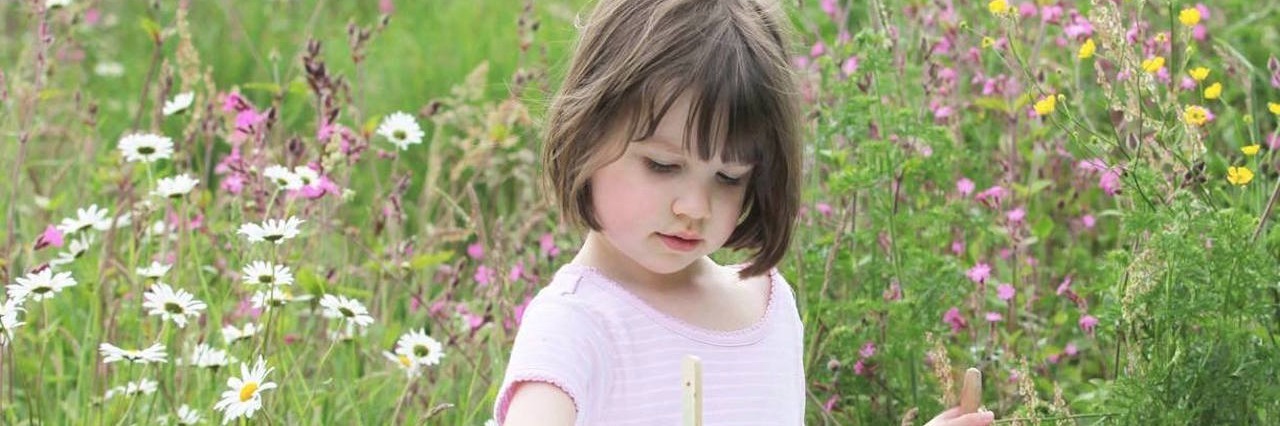 Book Follows Iris Grace Carter-Johnson, a Young Painter With Autism young girl painting outside