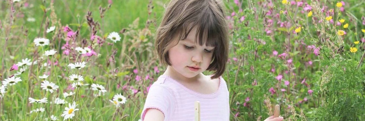 young girl painting outside