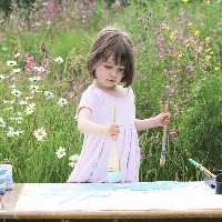 young girl painting outside