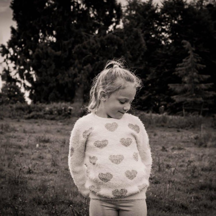 A girl standing in a field. 