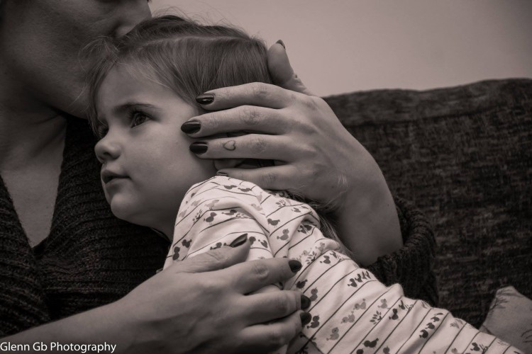 A Young girl being comforted. 