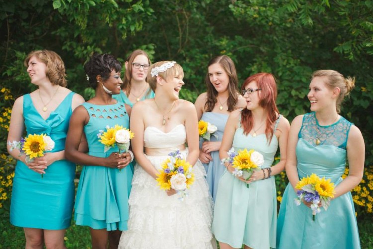 bride with bridesmaids wearing blue dresses