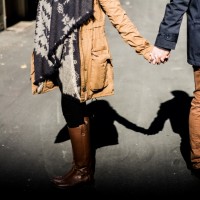 man and woman holding handsa