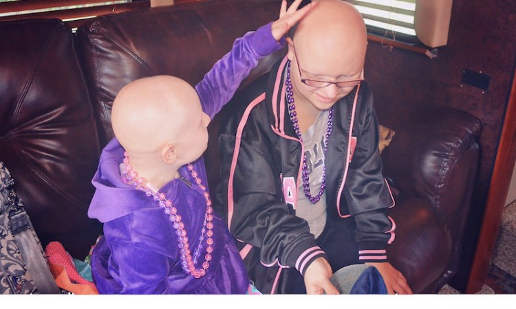 two girls wearing purple beaded necklaces