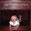 baby lying in drawer cabinet