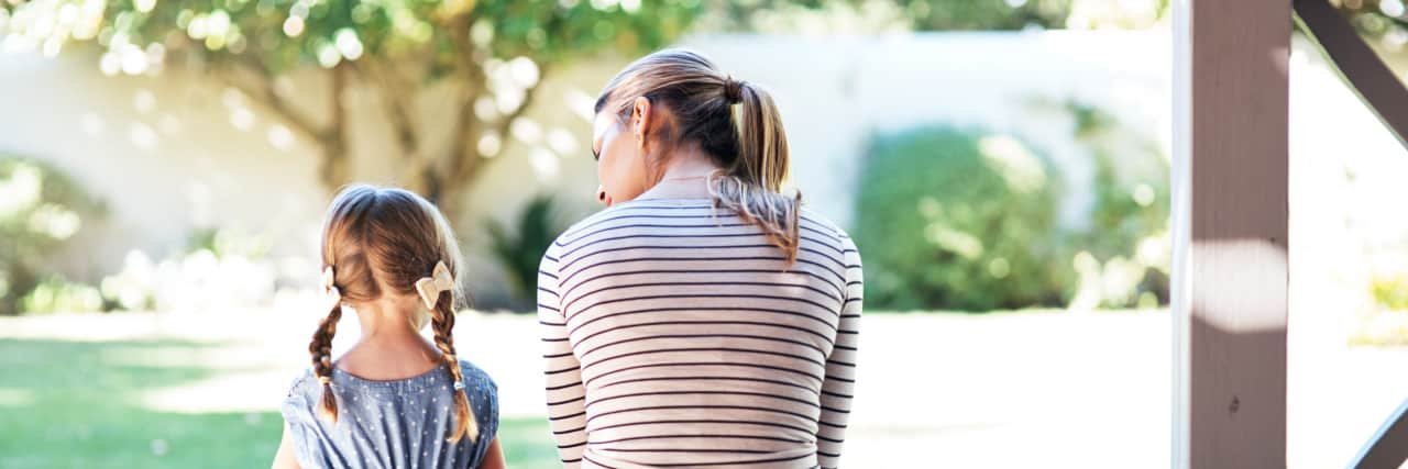 Rearview shot of a young woman and her daughter on a porch