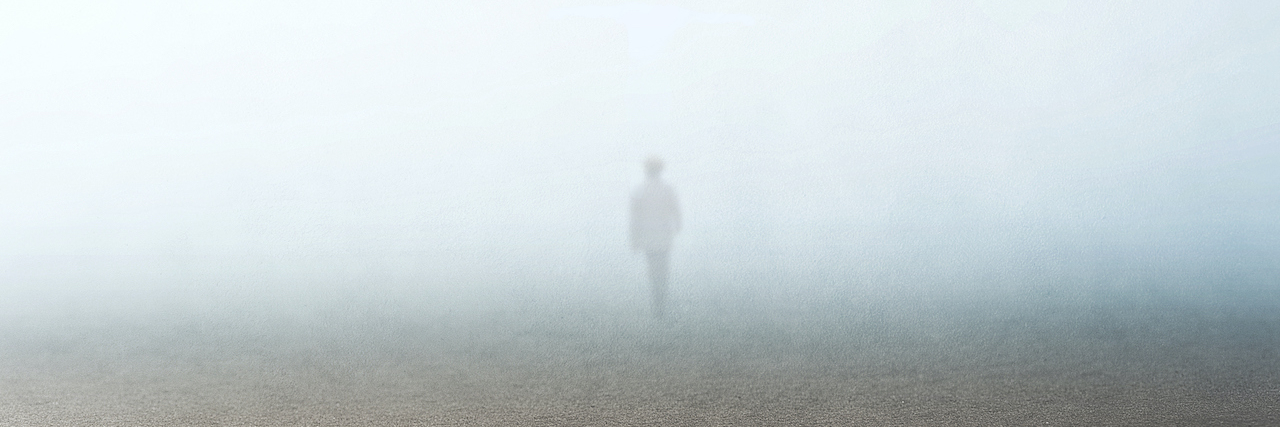 Person standing in fog