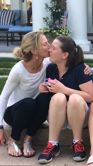 mother kissing daughter's cheek