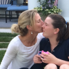 mother kissing daughter's cheek