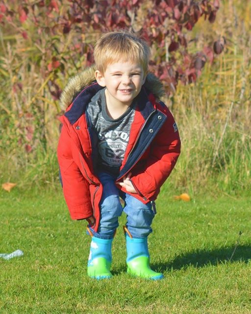 boy standing on grass