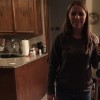 Brittany standing in the kitchen with her white cane