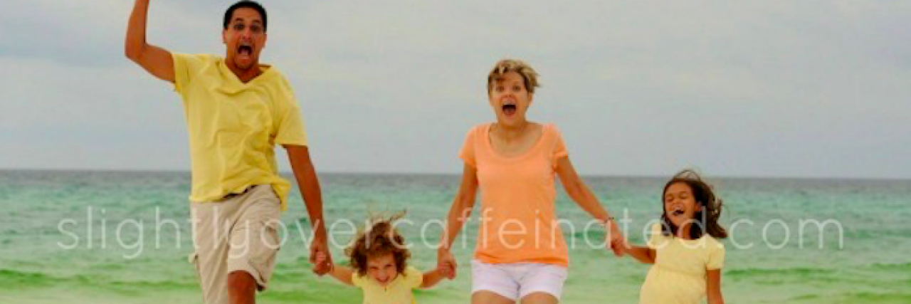 Family jumping on the beach