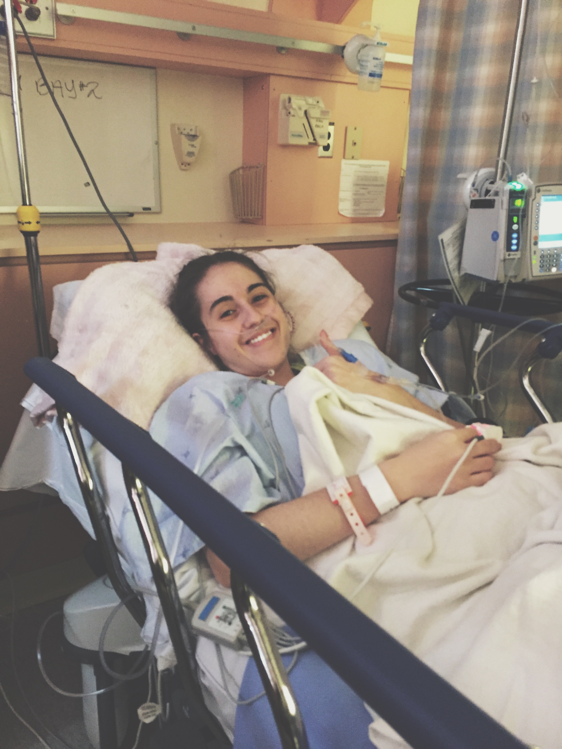 girl smiling in hospital bed