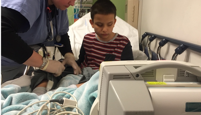 boy being treated in hospital bed