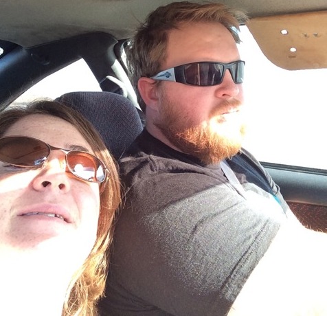 Man and woman wearing sunglasses in a car