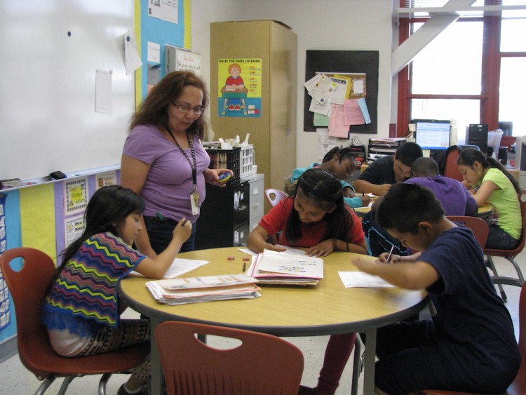 teacher and students sitting around table