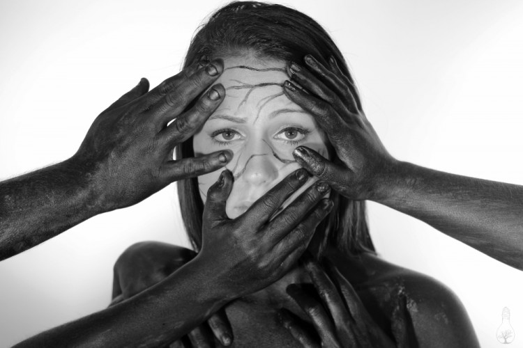 The black hands now cover the woman's face.