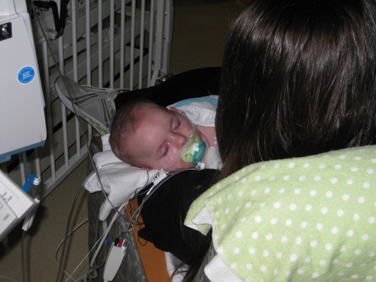 mom looking at baby in hospital