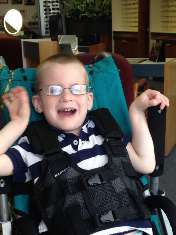 boy wearing glasses in wheelchair