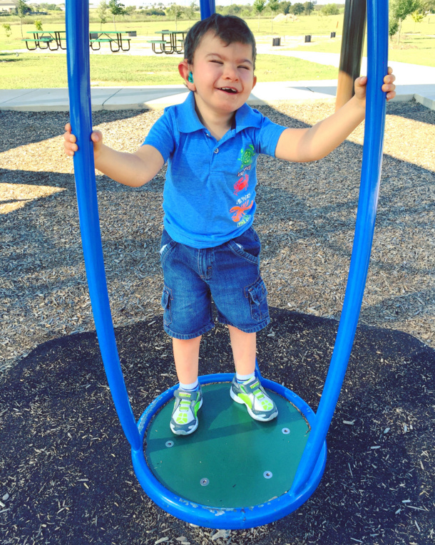 Boy with blue polo shirt on the playground