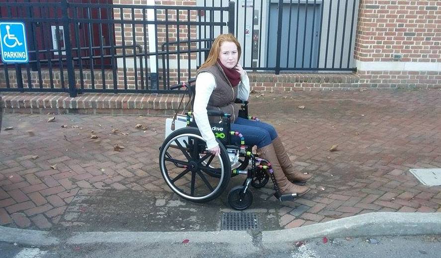 Woman in a wheelchair on a sidewalk