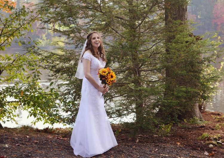 woman wearing wedding dress standing by trees