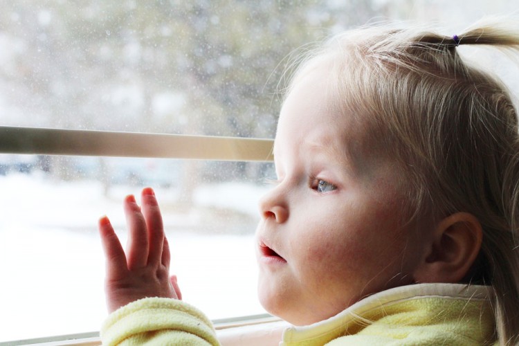 little girl looking out window