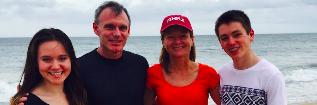 My 8 Life Hacks for Living Serenely With Chronic Illness Contributor and her family smiling on the beach: (man, woman, teenage boy and teenage girl)