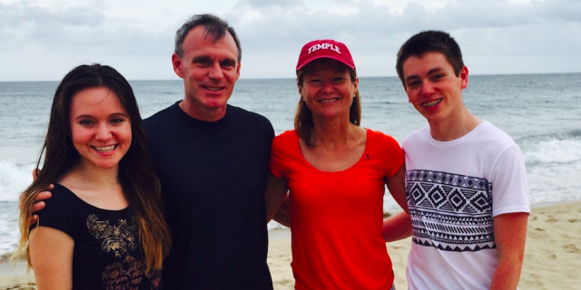 Contributor and her family smiling on the beach: (man, woman, teenage boy and teenage girl)