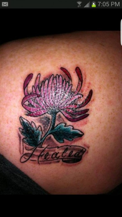 Tattoo of a flower with the words, "Healed"