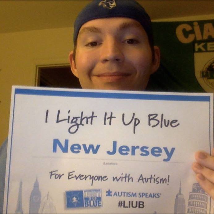 man holding light it up blue sign