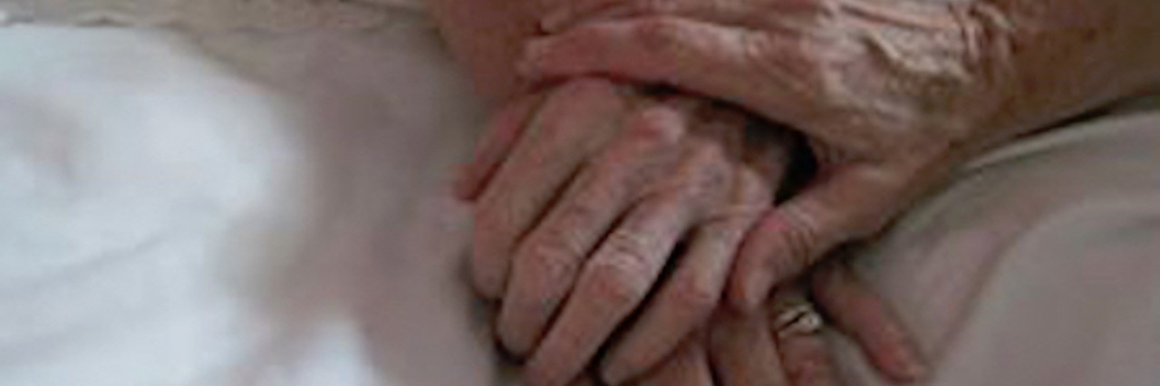 Forming a Relationship With My Mother's Hospice Nurse three women's hands on bed