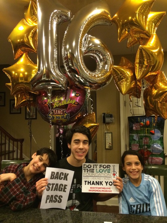 three boys under giant balloons