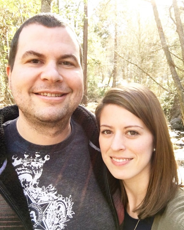 man and woman in forest surrounded by trees