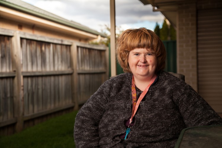 woman standing in backyard of house