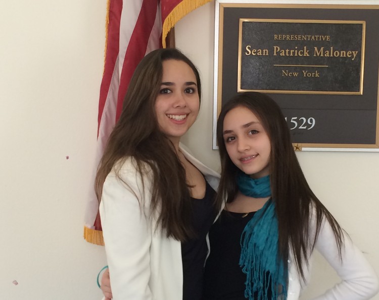 two girls in front of flag