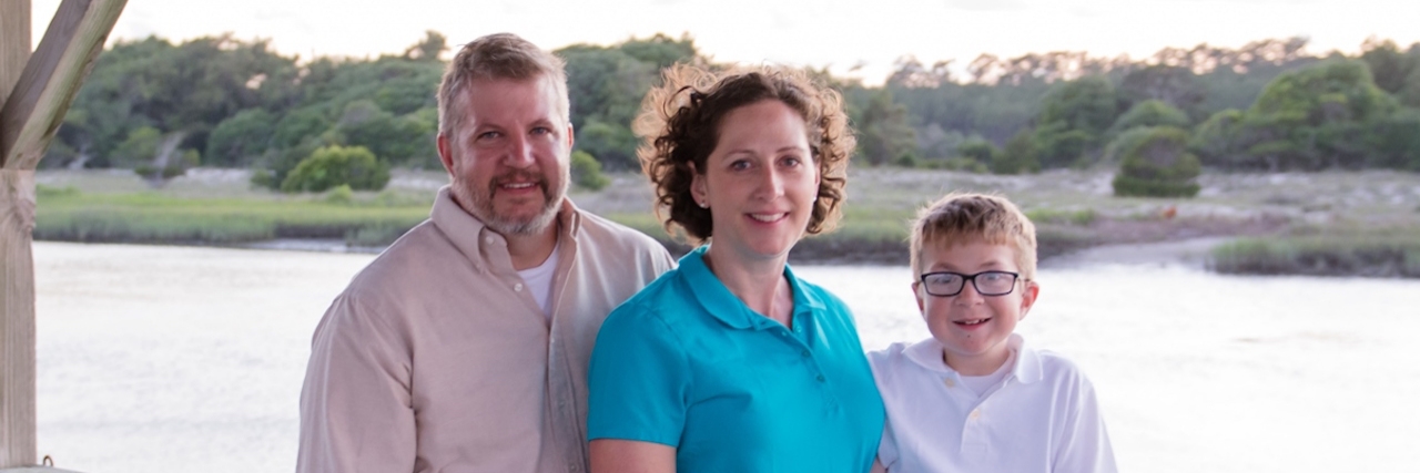 Hurler Syndrome: The Guide You Won't Find Online After the Diagnosis parents standing with son in front of a lake