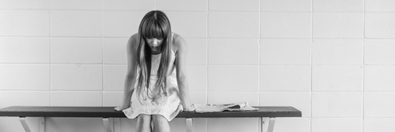 Feeling Guilty and Shameful After Parent's Suicide girl sitting alone on bench