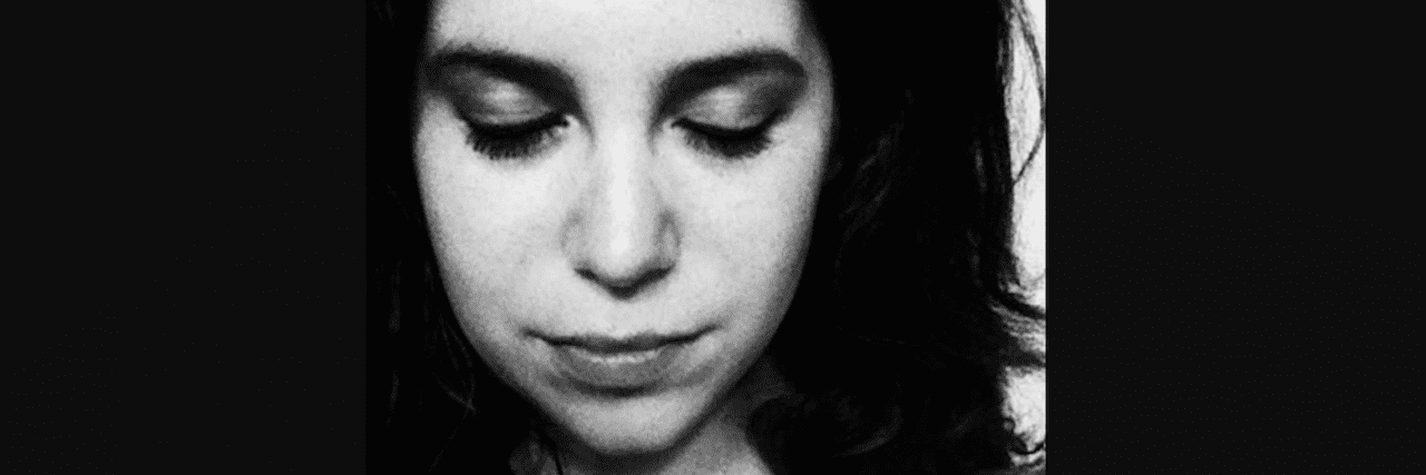 The Secrets of a Girl With Bipolar Disorder black and white photo of woman looking downward